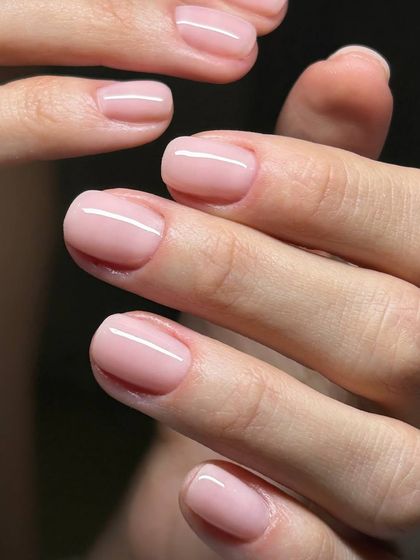 A classic, sheer pink manicure on short, natural nails. This is the perfect choice for a clean, polished, and professional look.