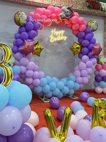 Here is another take on the popular unicorn theme, designed around a full balloon ring. The color palette of purple, pink, and blue, along with a large number '3' foil balloon, makes this a magical setup for a third birthday.