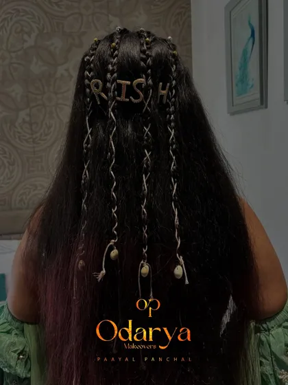 Your hairstyle can be as personal as you want it to be. For this bride's Mehendi, we did a fun boho hairstyle and even spelled out her fiancé's name with custom accessories.