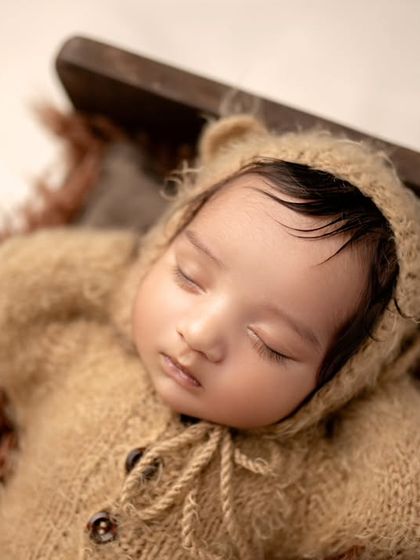 A close-up of our little bear cub, capturing the texture of the outfit and the baby's peaceful expression.