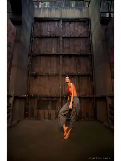 Only the best are always in motion. A dynamic shot of Lisa Haydon for a designer lookbook, set against a dramatic, industrial backdrop.