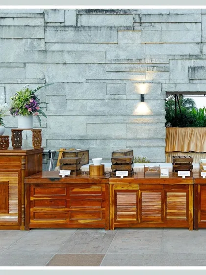 Our buffet counters are crafted from rich, polished wood, providing a warm and rustic foundation for the culinary display.