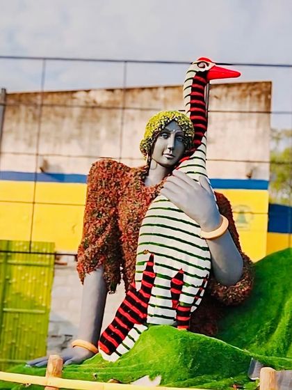 This project shows our ability to create three-dimensional sculptures using artificial greenery. Here, we crafted clothing and landscape elements for a statue, demonstrating our skill in artistic and unconventional applications.