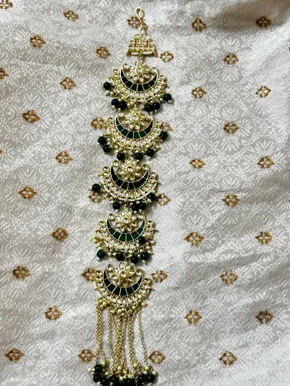 A Kundan hair choti with green Meenakari work and black bead drops. This rental accessory is designed to match my green bridal sets.