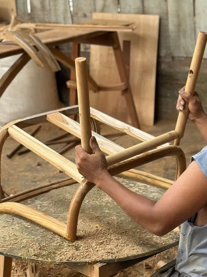 Here you can see the hands of a master craftsman assembling a chair frame in my workshop. Every joint is carefully fitted by hand, ensuring the strength and longevity of each piece of furniture I create.