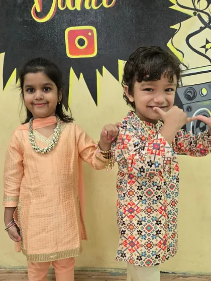 Another adorable pair ready to celebrate Krishna's birthday at the studio. The festive energy was amazing.
