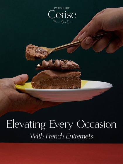 Elevating every occasion with French entremets. This image shows a hand delicately taking a spoonful from a slice of Mochaccino, emphasizing the art of indulgence.