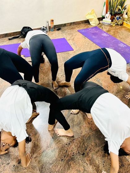 A group of students form a "Chakrasana Mandala," a wheel of wheel poses. This beautiful formation symbolizes unity, energy, and the interconnectedness of our community.