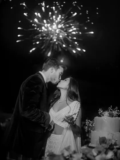 A magical moment as the couple kisses under a sky of fireworks. This perfectly timed black and white shot is the epitome of a fairytale wedding celebration.