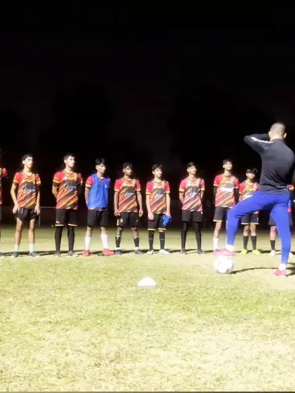 Our senior players listening intently as their coach imparts wisdom during a training session.