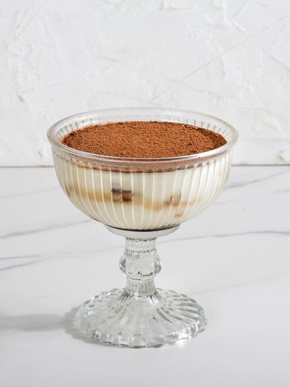 My Classic Tiramisu, with its layers of coffee-soaked ladyfingers and mascarpone cream, dusted with cocoa powder.