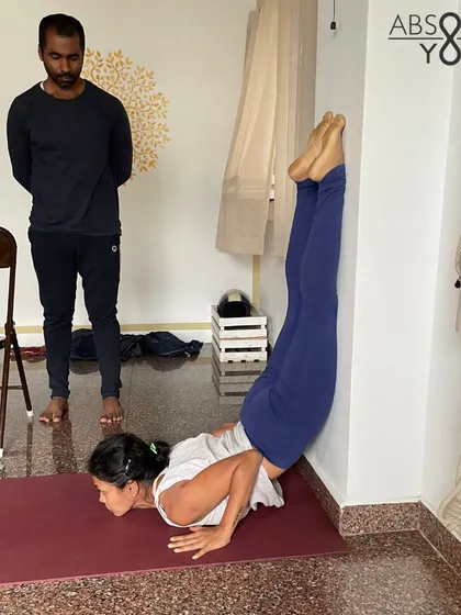 A student works on a supported backbend using the wall, a great way to build strength and confidence. Under the guidance of a teacher, props can help you safely explore challenging postures you thought were out of reach.