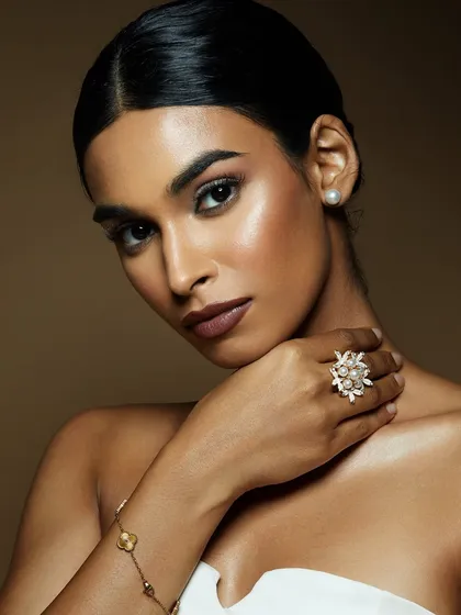 A classic, elegant look with flawless skin, a deep lip, and sparkling jewelry. This is timeless glamour, perfected.