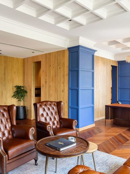 This office space features custom wood panelling and classic leather armchairs, all part of a cohesive design from our workshop. We believe in creating environments where every piece of furniture contributes to a unified and sophisticated narrative.