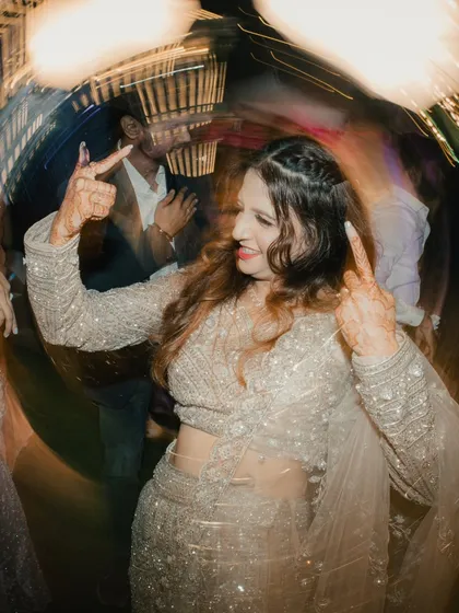 Capturing the fun on the dance floor. This creative shot with a circular blur effect focuses on the bride enjoying her engagement party.