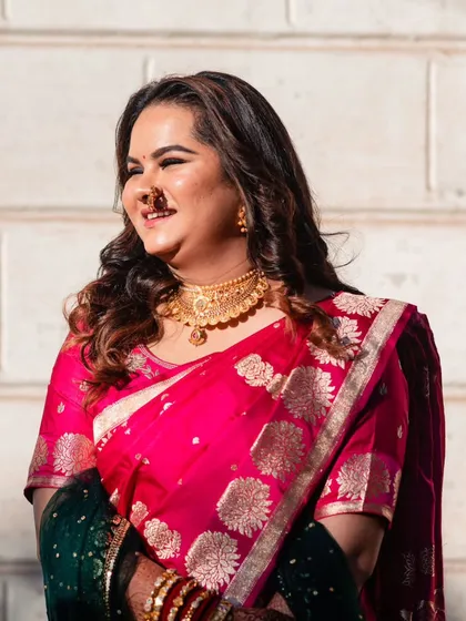 This client's happy, sunlit smile says it all. Her soft brown highlights add a gentle warmth that enhances her natural hair color and beautifully complements her traditional pink saree for the wedding ceremony.