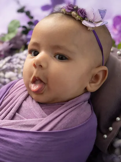A cheeky moment in a field of lavender. This 3-month-old's playful expression is what makes milestone sessions so much fun.
