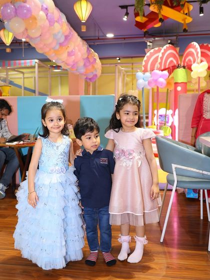 Three friends posing for a photo at the party. Our venue provides a bright and cheerful backdrop for all your pictures.