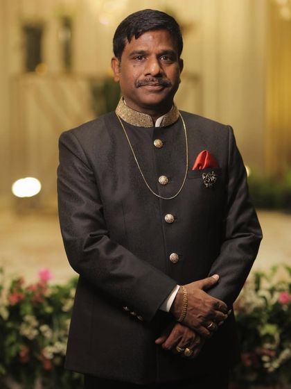 Mr. Sanjay Jain, the father of the bride, in his custom Levelline bandhgala. The gold-embroidered collar and classic cut exude timeless grace.
