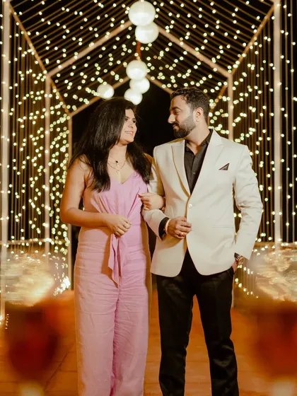 A romantic walk through a tunnel of fairy lights. This setup creates a magical, dreamlike atmosphere that is perfect for evening pre-wedding photos.