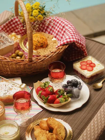 A full poolside picnic spread, featuring our basket and an array of our finest cheeses, desserts, and fresh fruits. It’s the ultimate way to relax and indulge.