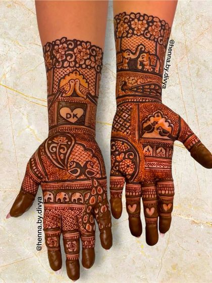 A sweet engagement design featuring the initials 'DK' inside a heart, lovebirds, and elephants, all symbolizing love and commitment.