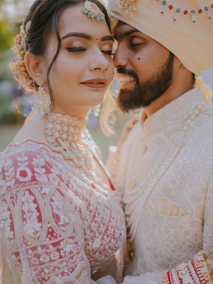 A close-up of Ajay and Vaishali, their eyes closed in a moment of pure bliss. The warm, sunny glow adds to the romantic atmosphere.