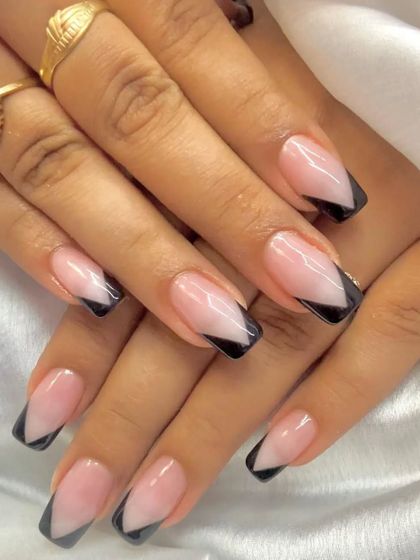 A V-shaped black French manicure on square-tipped nails.