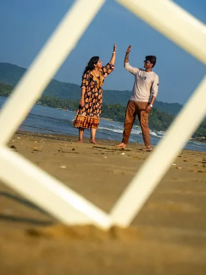 A celebratory high five between the couple, captured within the frame. This shot is full of positive energy and shows the fun side of their relationship.