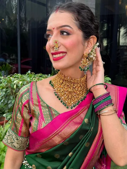 For the Ganpati festival, I created this traditional Maharashtrian look for myself. The bold red lip, classic nath, and gajra bun celebrate our rich culture. We love creating authentic, radiant looks for all your festive occasions.