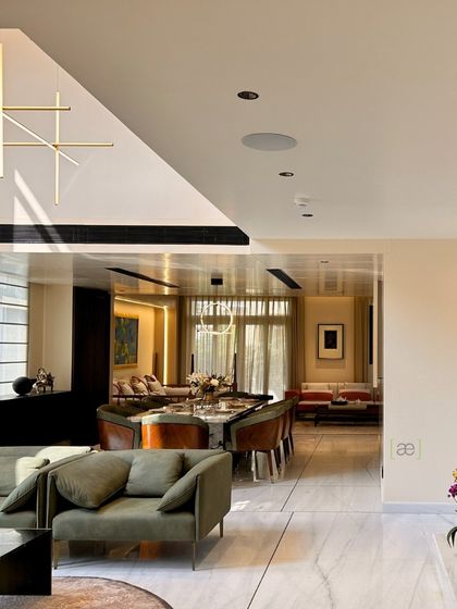 A view from the living area looking towards the dining space in the Palm Springs Villa. The open-plan layout and consistent material palette create a seamless flow between different functional zones.