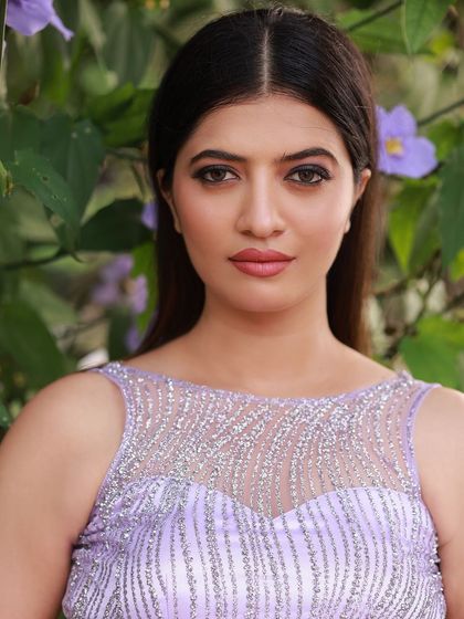 A designer shoot for a modern lavender lehenga. The images were taken in a lush garden, with the purple flowers complementing the color of the outfit, creating a soft and romantic fashion story.