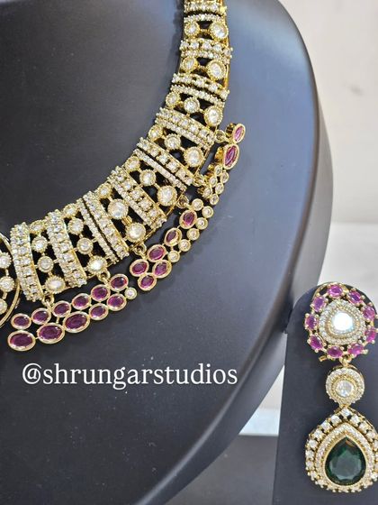 A close-up of the necklace, showing the intricate design and the vibrant colors of the stones.