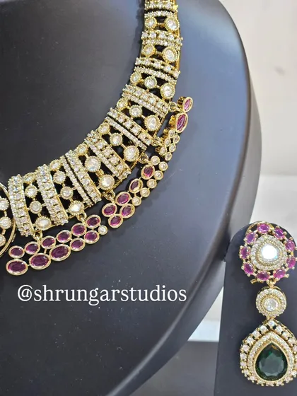 A close-up of the necklace, showing the intricate design and the vibrant colors of the stones.