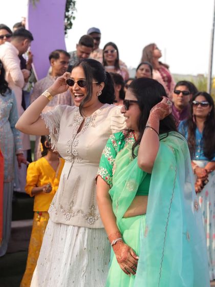 Sharing a laugh with a guest during a daytime wedding event. It's these small, personal interactions that make a big difference in making everyone feel comfortable and included.