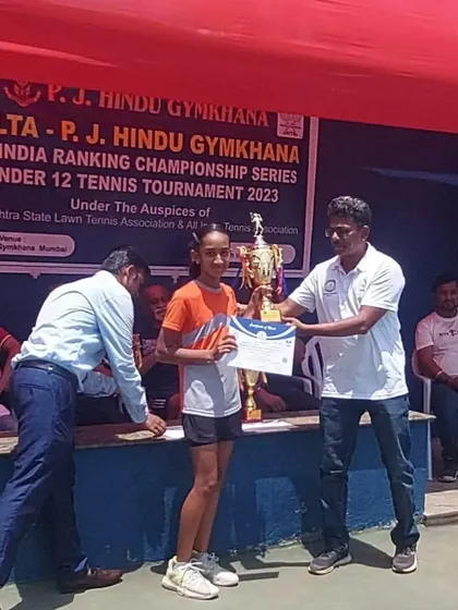 Rumi Gadia receiving her winner's trophy at the prize ceremony.