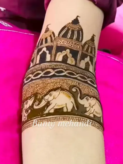 A close-up of an arm band design featuring a procession of elephants below a traditional Rajasthani palace motif.