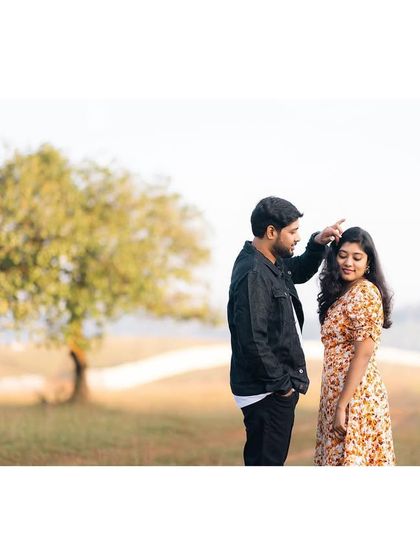 A playful and tender moment during Anitha and Mohan's pre-wedding shoot in the countryside.