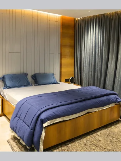 A comparison of the initial 3D render and the final built bedroom. This showcases our ability to translate a design concept into a tangible space, matching the textures, colors, and lighting as envisioned.