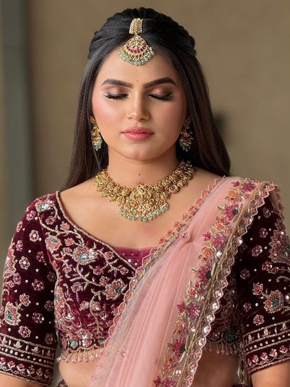 A close-up of a bride's reception makeup, featuring a soft, blended eyeshadow in warm tones and a neutral lip.