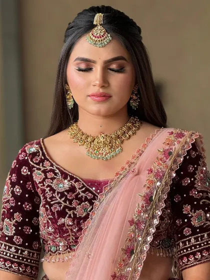 A close-up of a bride's reception makeup, featuring a soft, blended eyeshadow in warm tones and a neutral lip.