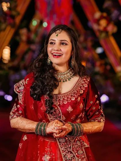 Pure joy and glamour for a reception night. This look features soft, curly hair and luminous makeup that shines bright, perfect for celebrating and making unforgettable memories.