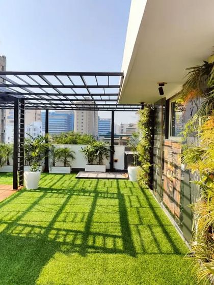 A wide shot of the South City 2 terrace, showcasing the long vertical garden, pergola, and planters that transform the entire length of the space.