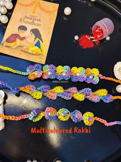 For a pop of fun, choose our multicoloured floral rakhi. The vibrant, blended yarn makes each rakhi unique.