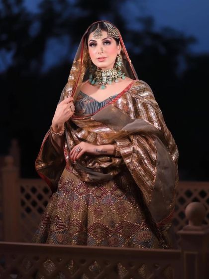 A stunning shot of the bride against the evening sky, looking absolutely regal.
