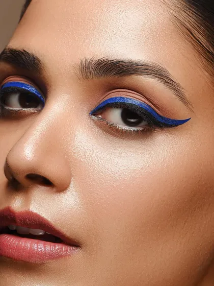 An even tighter crop from our blue eyeliner series, this image shows the detail and precision of the makeup application. This type of macro beauty shot is ideal for showcasing specific cosmetic products or techniques.