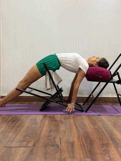 This sequence of images shows multiple variations of Purvottanasana (Upward Plank Pose) using chairs and bolsters. These props help to support the body, reduce strain on the wrists, and allow the student to focus on opening the chest and strengthening the back.