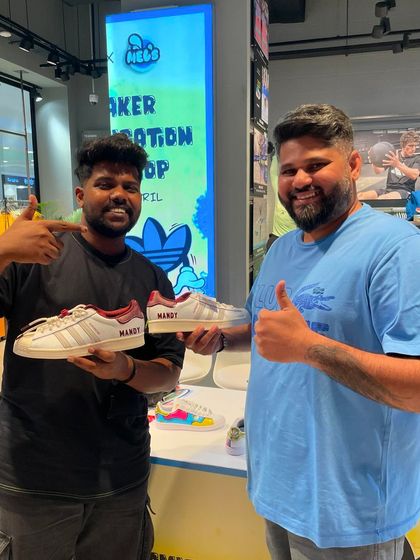 Another happy customer gets his name, Mandy, painted onto his sneakers, creating a truly one-of-a-kind pair.