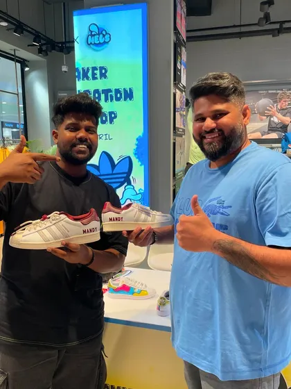 Another happy customer gets his name, Mandy, painted onto his sneakers, creating a truly one-of-a-kind pair.