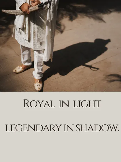 "Royal in light, legendary in shadow." This artistic shot captures the groom's regal presence, focusing on his traditional attire and the strong shadow he casts, symbolizing strength and heritage.